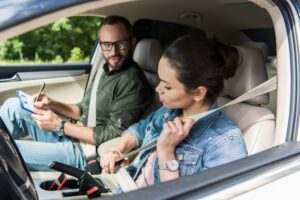Learner driver fastening seat belt before a VicRoads driving test taken as part of a Lesson + Test package