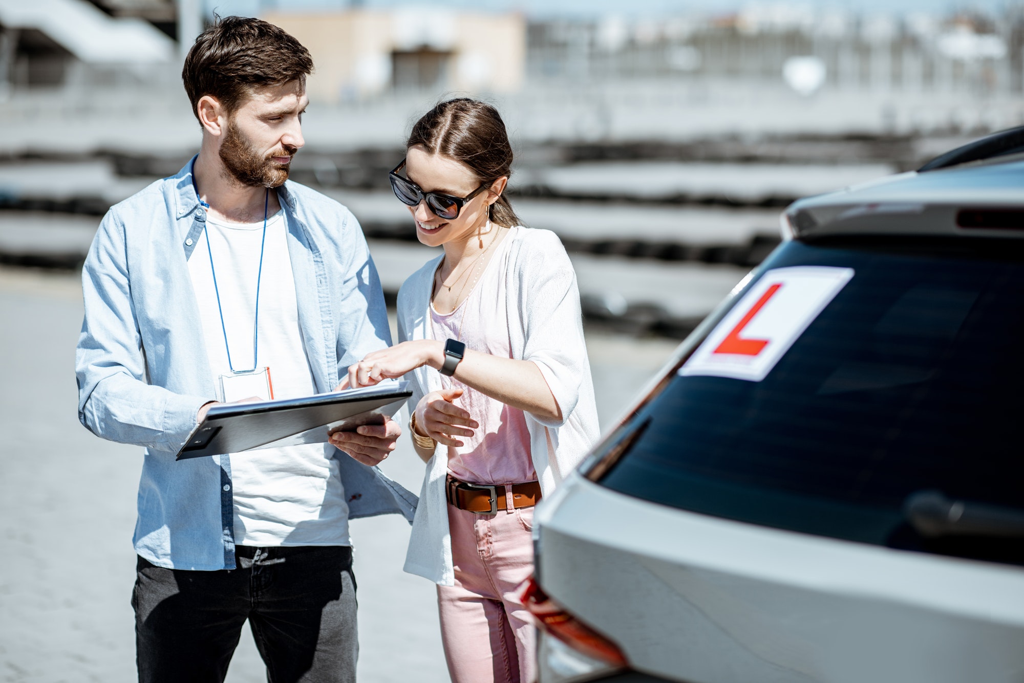 Mitcham Driving School instructor walking a learner through a dual-control lesson outdoors in eastern Melbourne